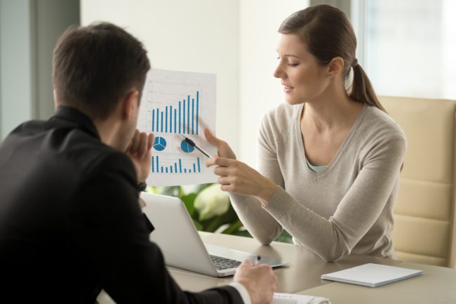 Female entrepreneur showing graph on ways to increase revenue