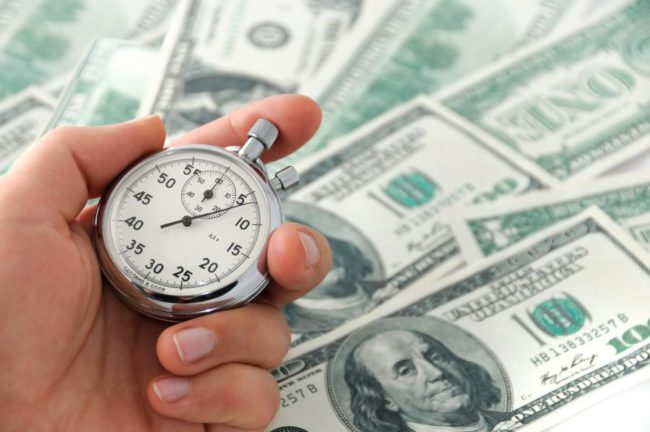 Stop watch with cash showing fast business funding