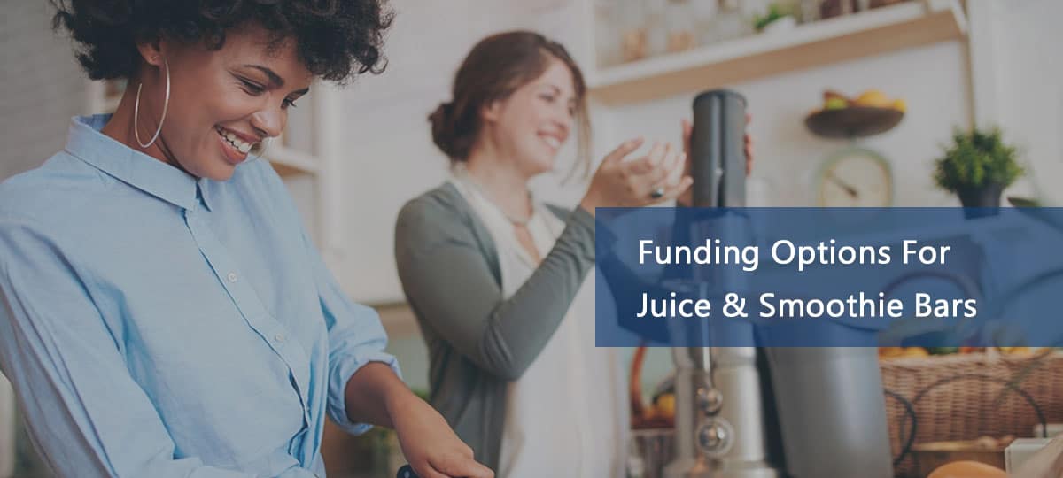 Two women making smoothies at thier new juice smoothie bar location