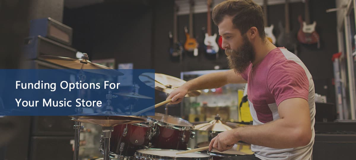 Customer testing a drum set in music store