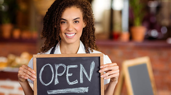 New business owner holding an open sign